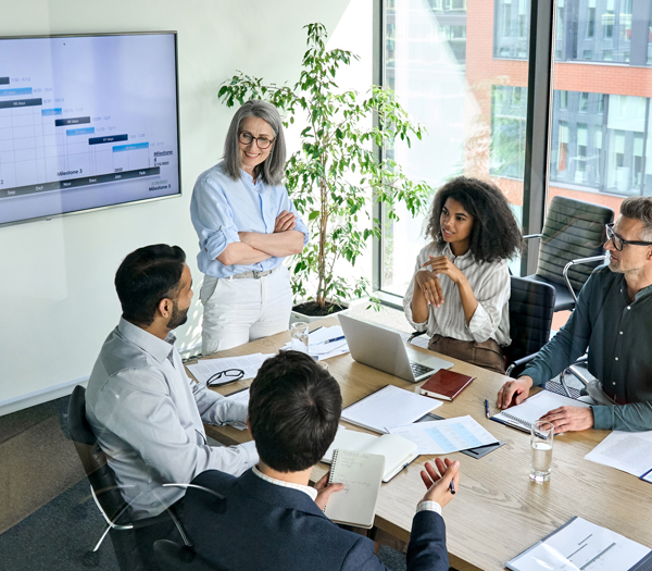 Diverse corporate team working together in modern meeting room office.